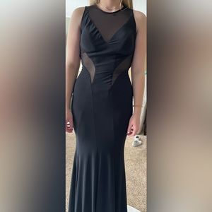 Black floor length sleeveless dress worn